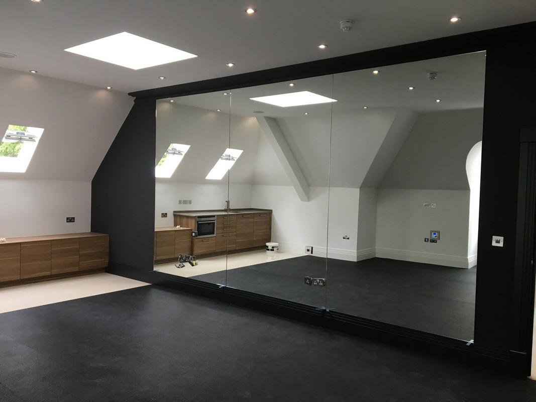 Frameless glass wall dividing loft conversion in Deptford