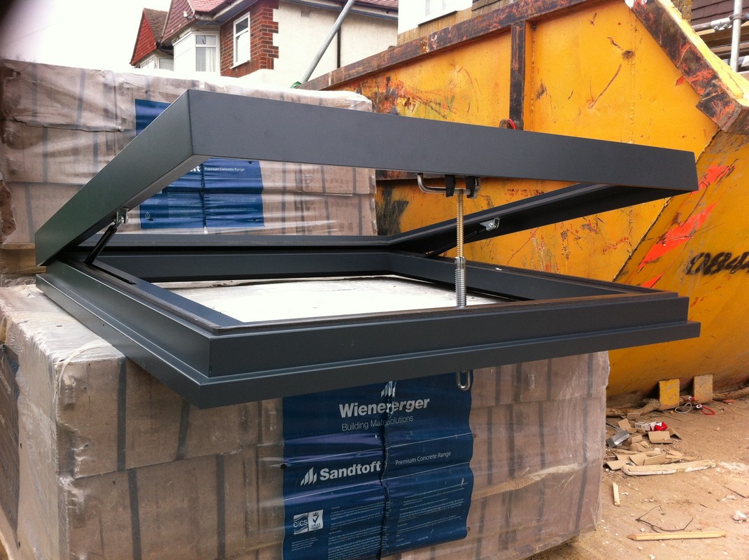 Opening flat roof skylight in anthracite grey installed in Deptford