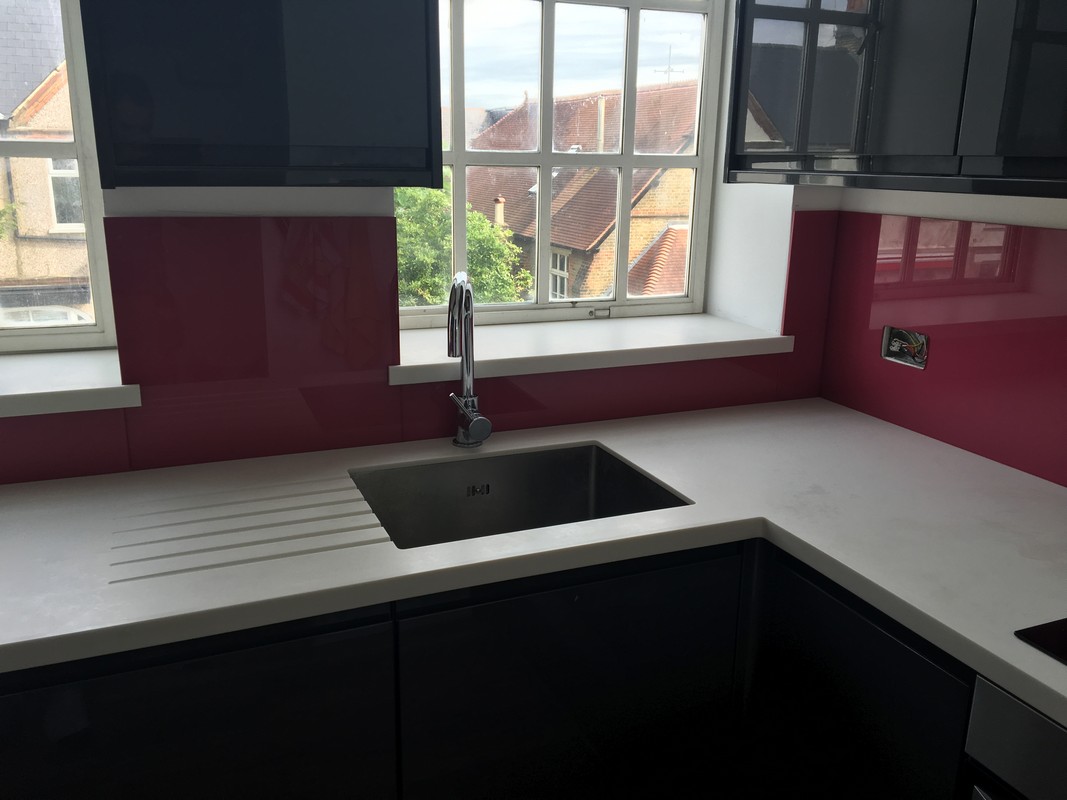 Deep plum coloured glass splashback in modern Deptford kitchen